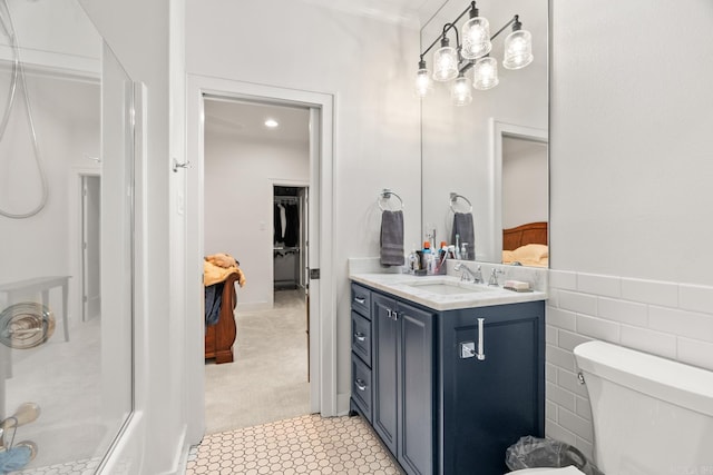 bathroom featuring tile walls, tile patterned floors, vanity, and toilet