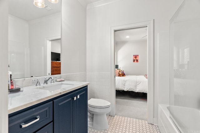 bathroom with toilet, tile walls, tile patterned floors, crown molding, and vanity