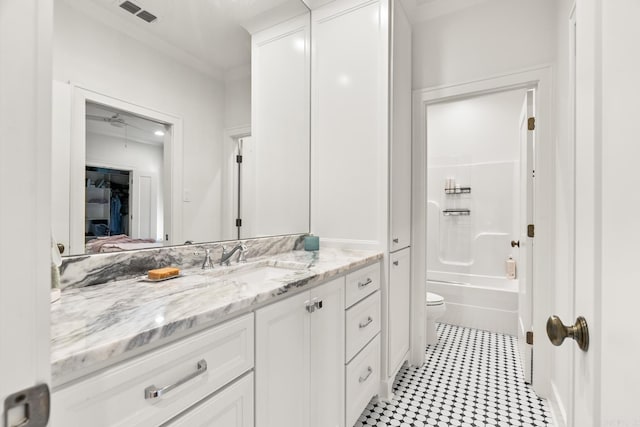 full bathroom featuring tub / shower combination, vanity, and toilet