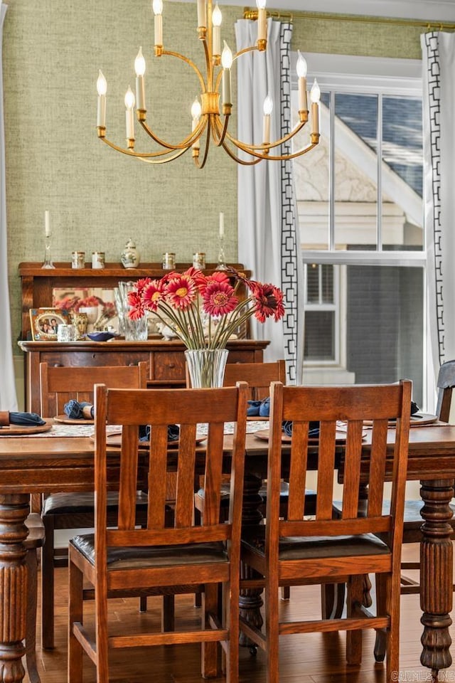 dining area featuring wood-type flooring and a chandelier