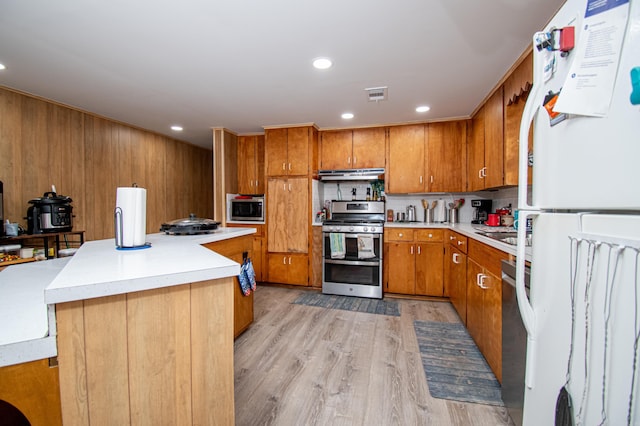 kitchen with a center island, light hardwood / wood-style flooring, and appliances with stainless steel finishes