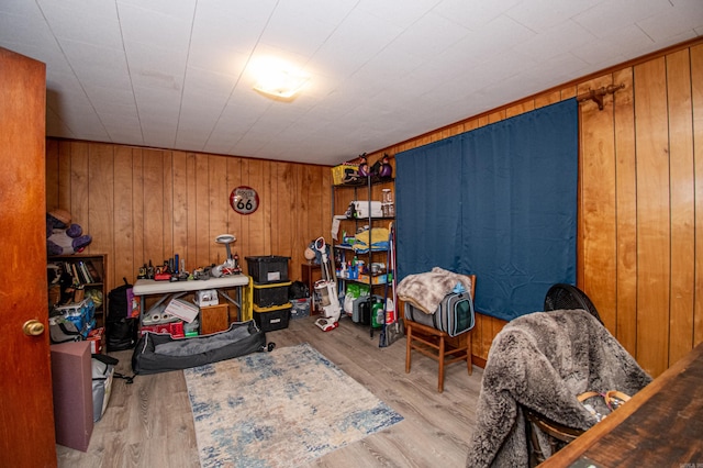 interior space featuring light hardwood / wood-style floors and wood walls