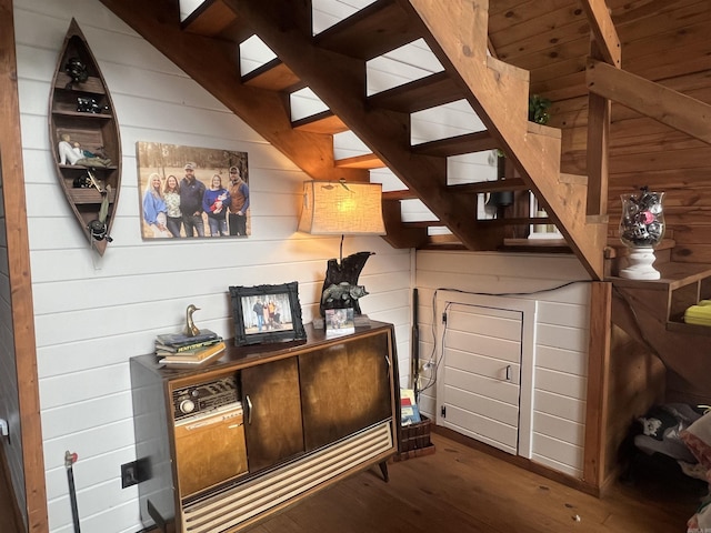 interior space with wooden walls and wood finished floors