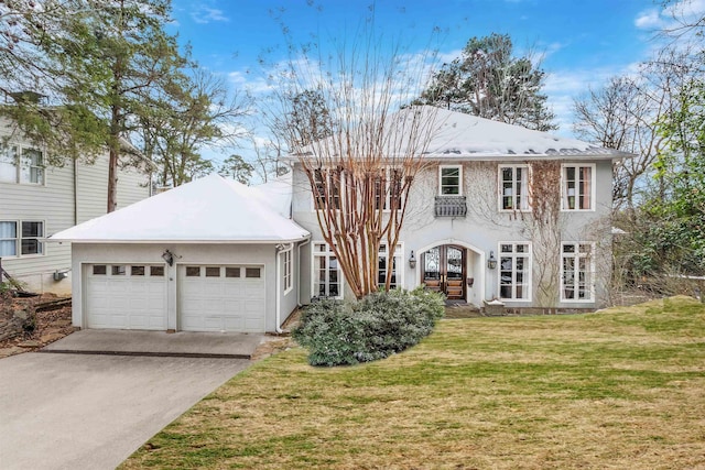 view of front of house featuring french doors, a front lawn, and a garage