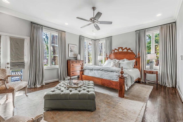 bedroom featuring ceiling fan, dark wood-type flooring, ornamental molding, and multiple windows