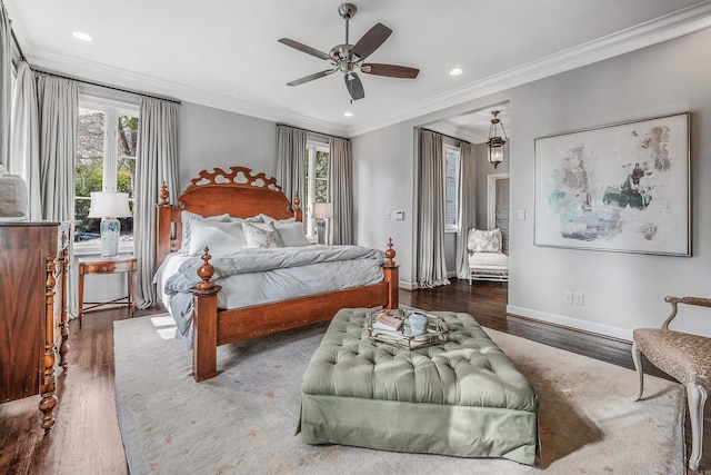 bedroom featuring ornamental molding, ceiling fan, dark hardwood / wood-style flooring, and multiple windows