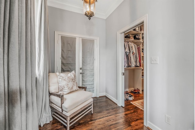 living area with crown molding and dark hardwood / wood-style floors