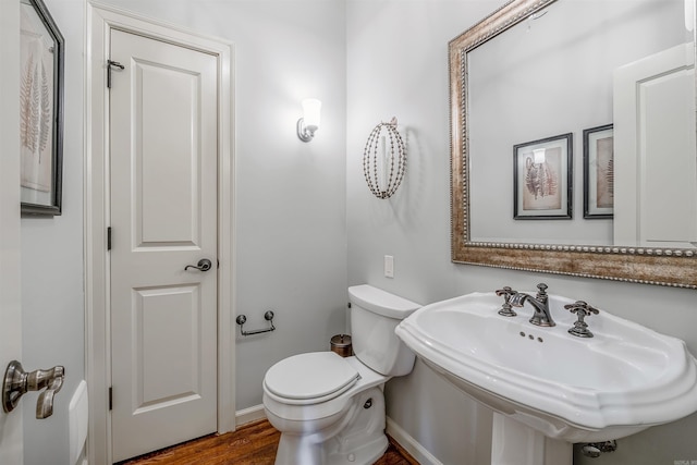 bathroom featuring sink, wood-type flooring, and toilet