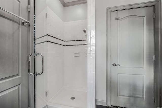 bathroom with walk in shower and ornamental molding