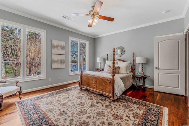 bedroom featuring ceiling fan, crown molding, and dark wood-type flooring