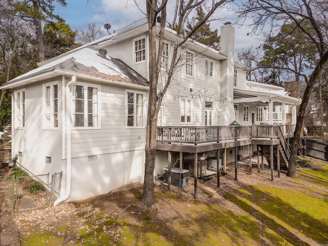 rear view of property featuring a deck