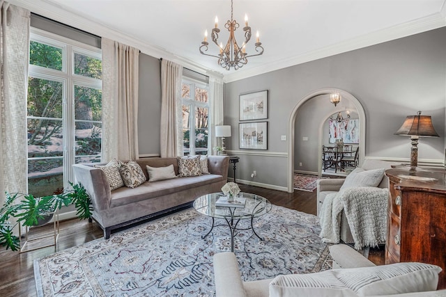 living room with a notable chandelier, crown molding, and dark hardwood / wood-style floors