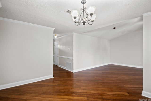 unfurnished dining area with an inviting chandelier, a textured ceiling, crown molding, and dark wood-type flooring