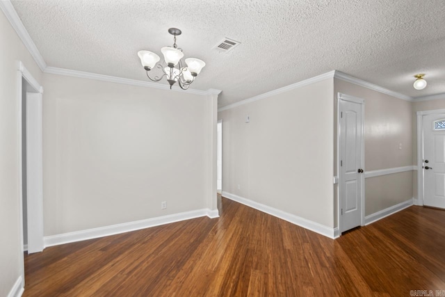 unfurnished room featuring a textured ceiling, a notable chandelier, crown molding, and dark hardwood / wood-style flooring