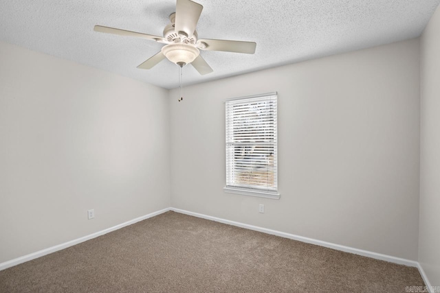 spare room with carpet floors and ceiling fan