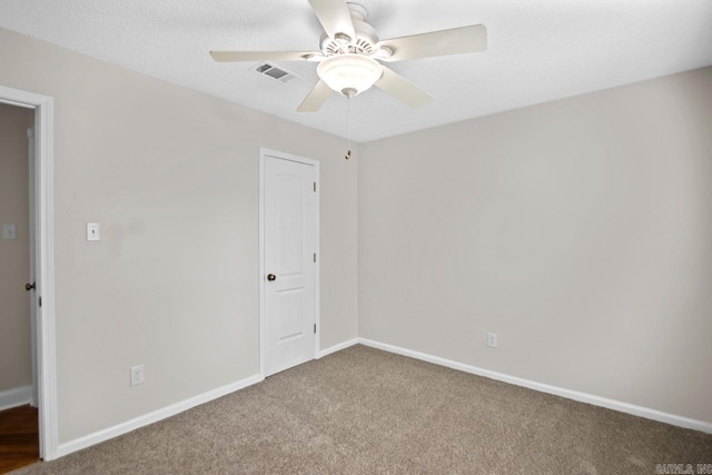 unfurnished room with ceiling fan and carpet flooring