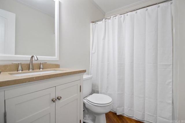 bathroom featuring toilet, vanity, hardwood / wood-style floors, and crown molding