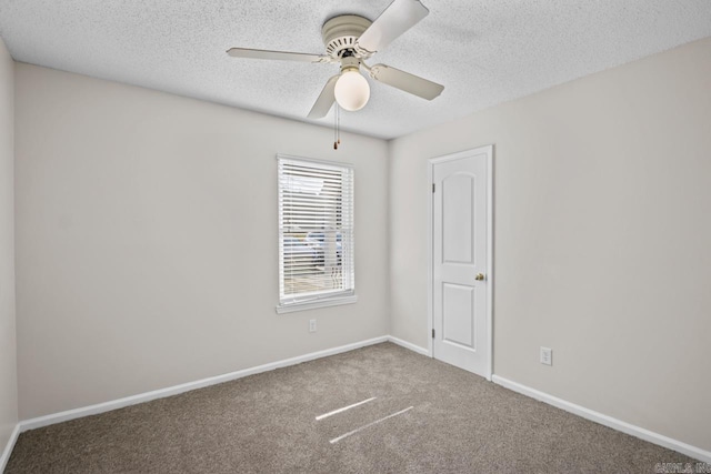 spare room featuring ceiling fan, carpet floors, and a textured ceiling