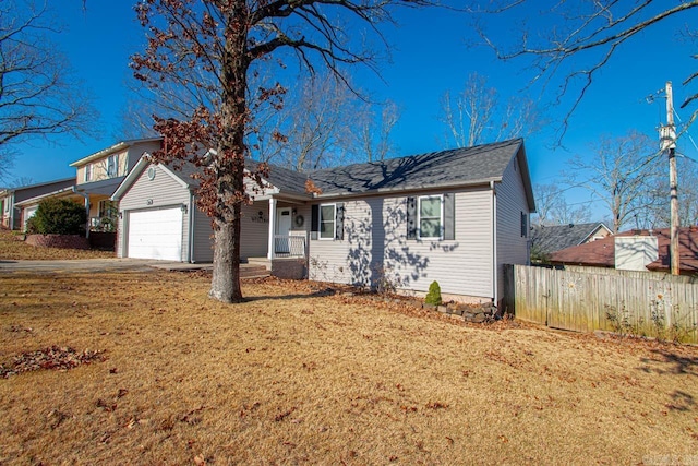 view of front of property featuring a front yard and a garage