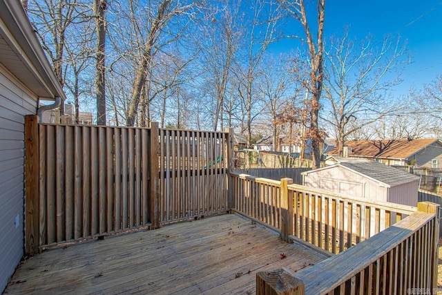 wooden terrace featuring a storage unit