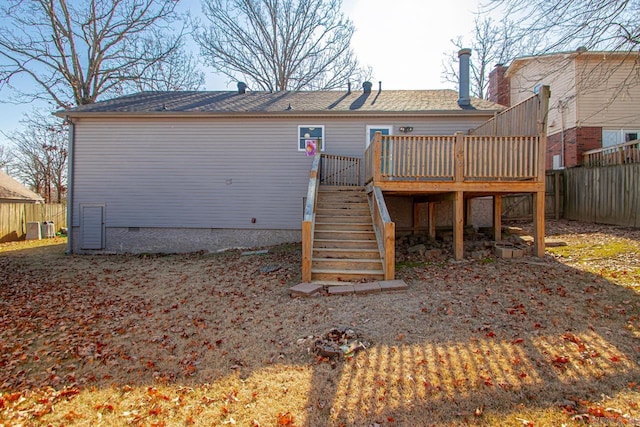 rear view of property with a deck and central AC