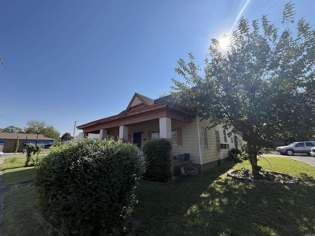 view of property exterior featuring a lawn