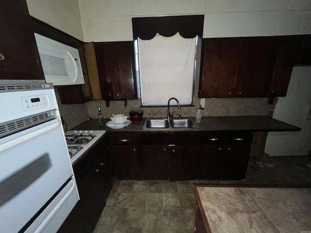 kitchen with white appliances, dark brown cabinetry, decorative backsplash, and sink