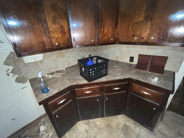 kitchen with dark brown cabinets and decorative backsplash