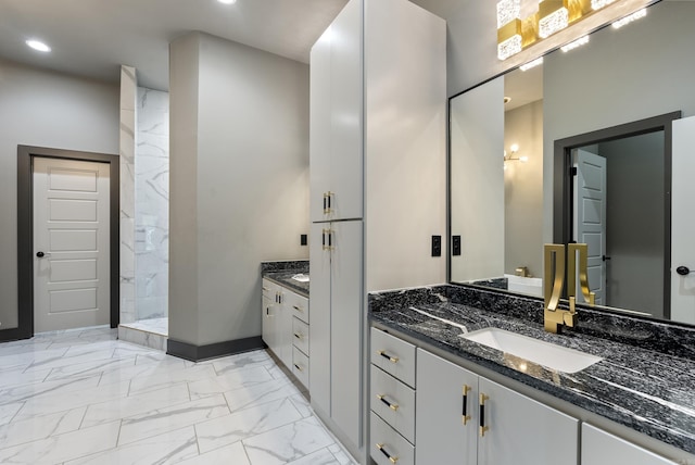 bathroom with walk in shower and vanity