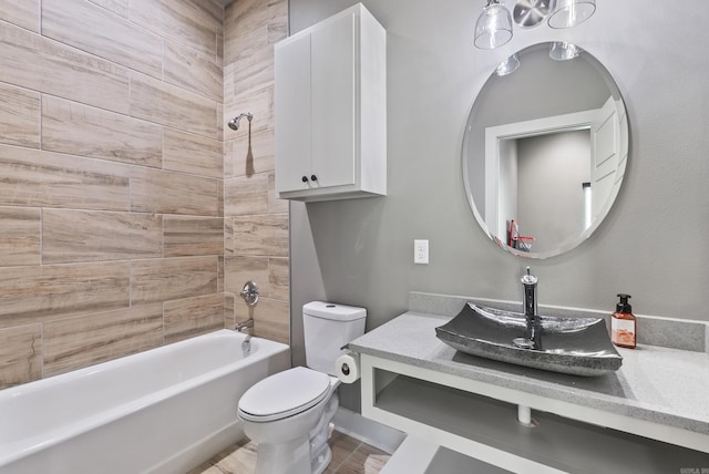 full bathroom featuring vanity, tiled shower / bath combo, and toilet