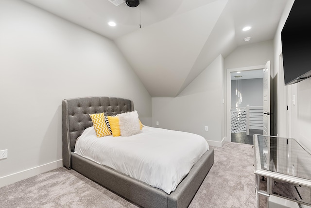 bedroom featuring ceiling fan, vaulted ceiling, and carpet flooring