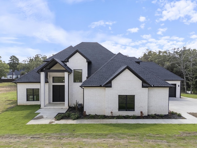 view of front of house with a front yard and a garage