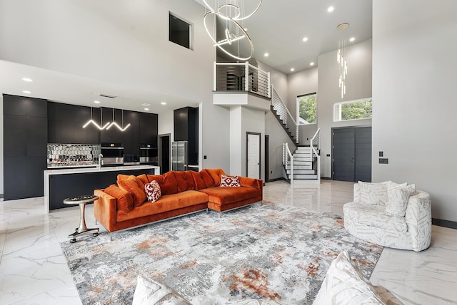 living room featuring a notable chandelier and a towering ceiling