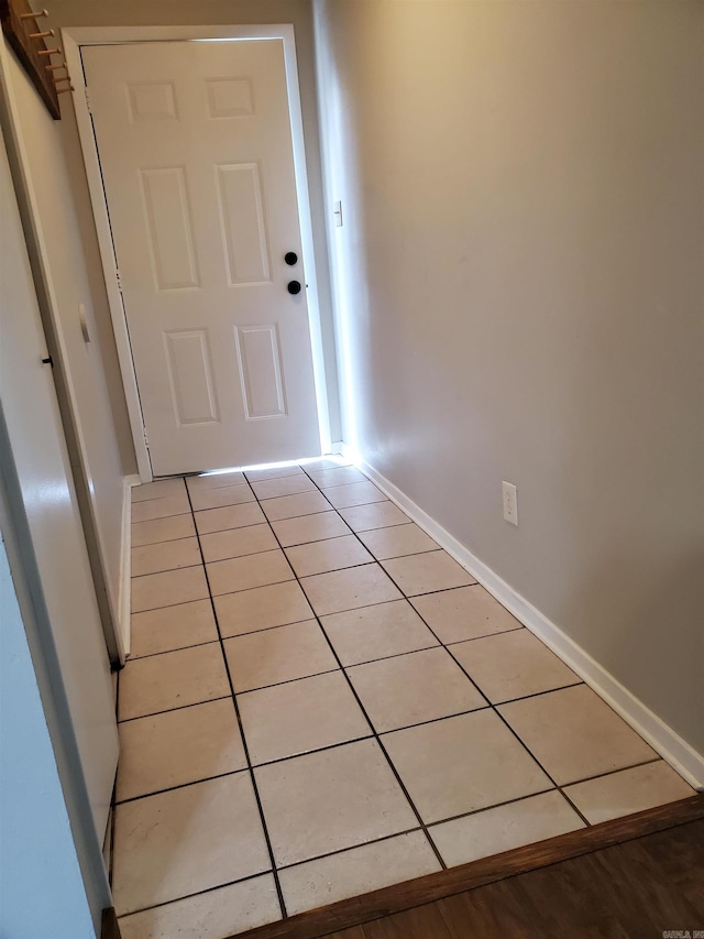 doorway with light tile patterned flooring