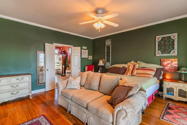 bedroom with hardwood / wood-style floors, ceiling fan, and crown molding