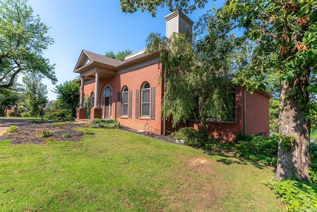 view of home's exterior with a yard