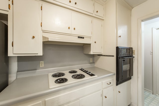 kitchen featuring white stovetop, white cabinetry, and black oven