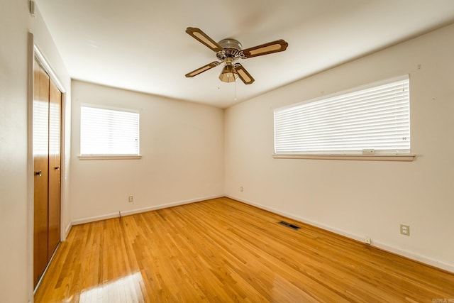 unfurnished room featuring light wood-type flooring and ceiling fan