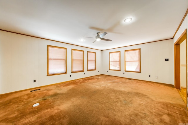 carpeted empty room featuring ceiling fan and crown molding