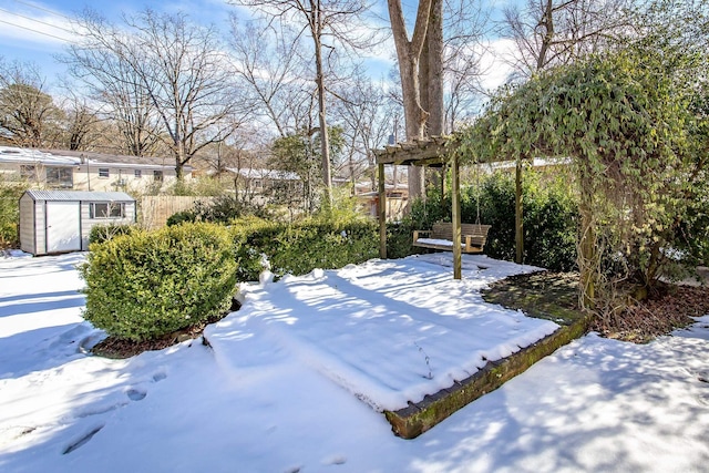 snowy yard with a shed