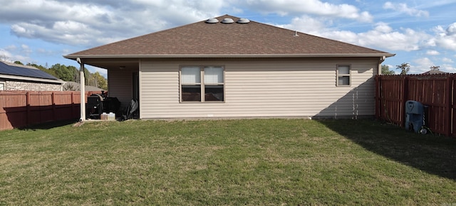 rear view of house featuring a lawn