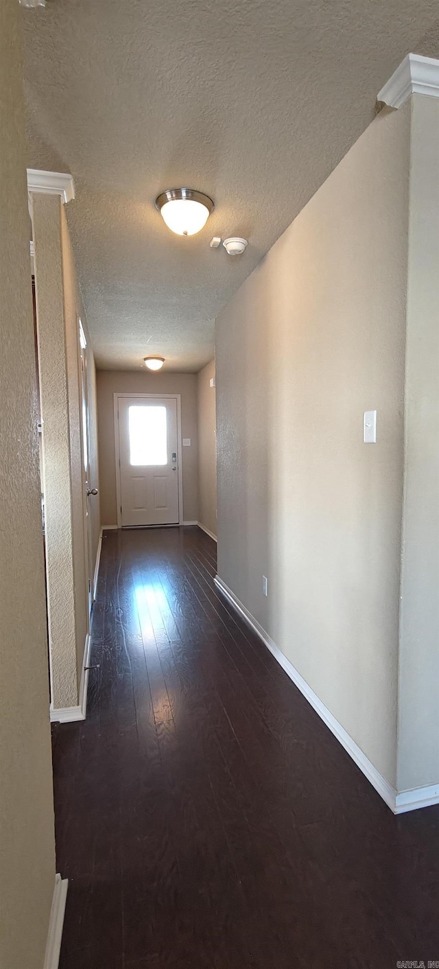 spare room with dark hardwood / wood-style flooring and a textured ceiling