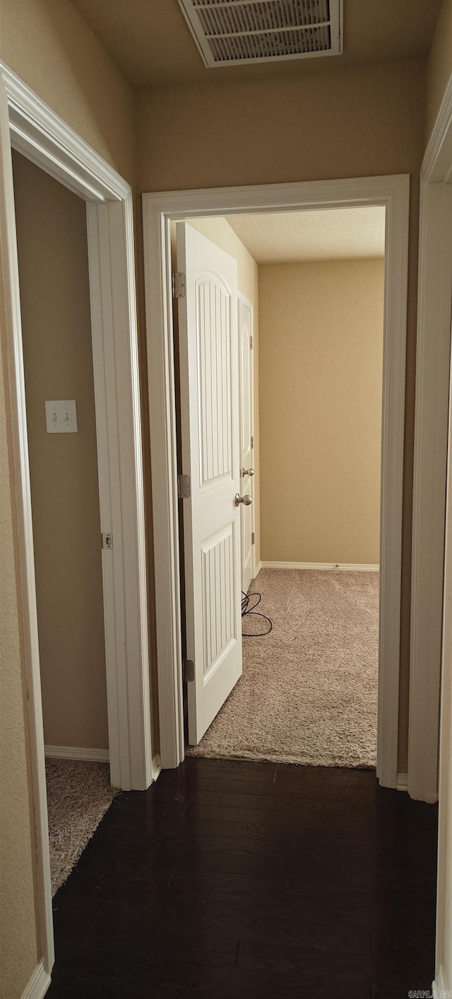 hallway with dark wood-type flooring