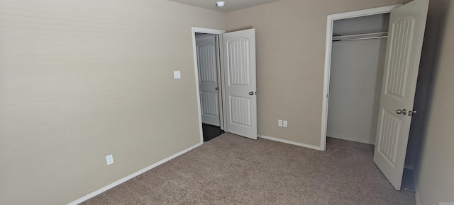 unfurnished bedroom with light colored carpet and a closet