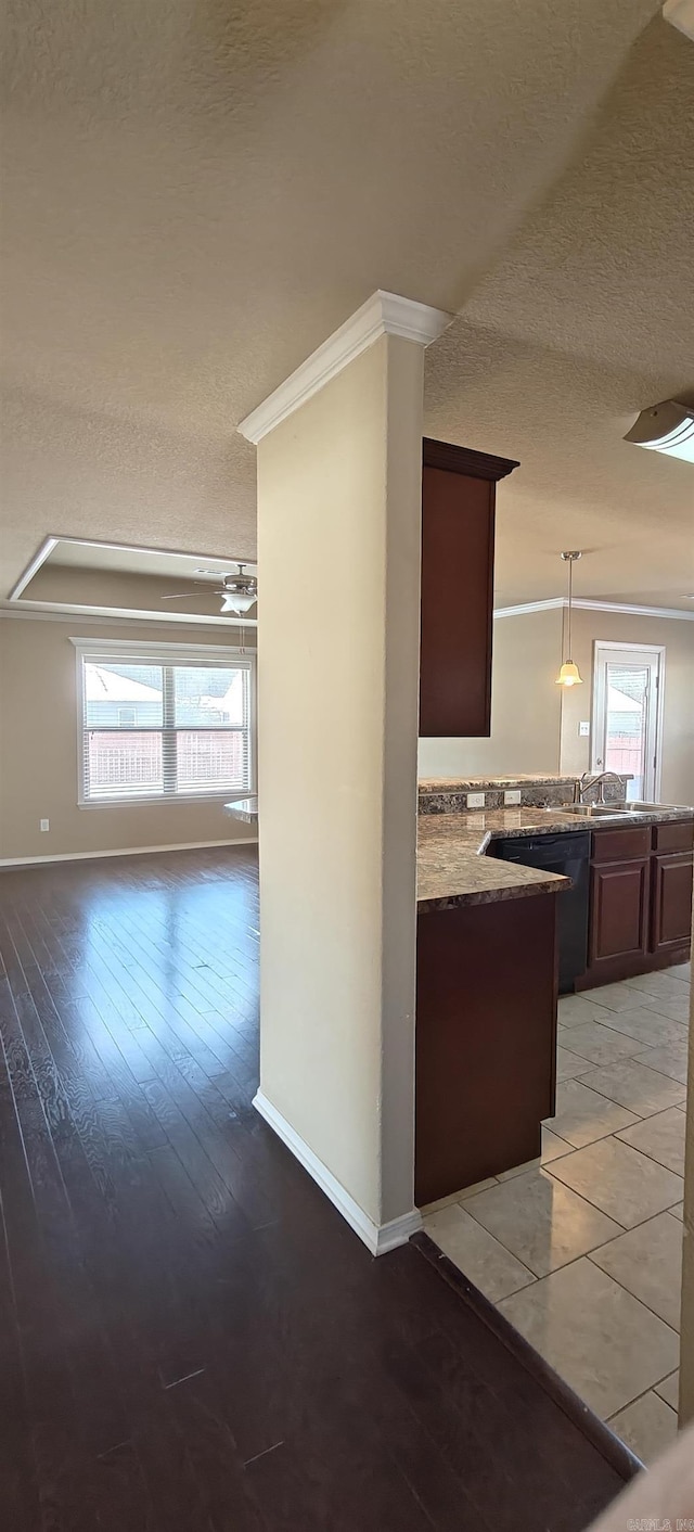 kitchen with dishwasher, light hardwood / wood-style flooring, decorative light fixtures, ornamental molding, and dark brown cabinetry