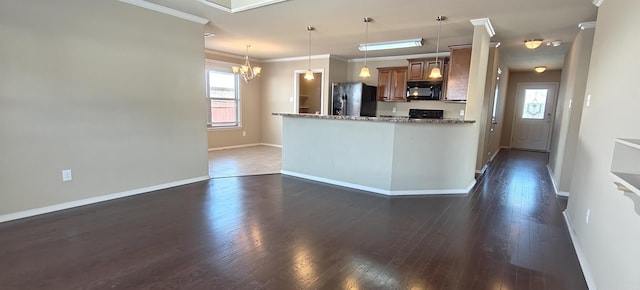 kitchen with ornamental molding, light stone countertops, hanging light fixtures, dark hardwood / wood-style floors, and black appliances