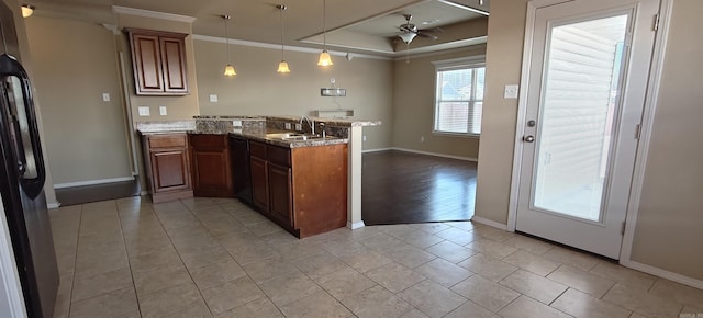 kitchen with black appliances, kitchen peninsula, ceiling fan, pendant lighting, and sink