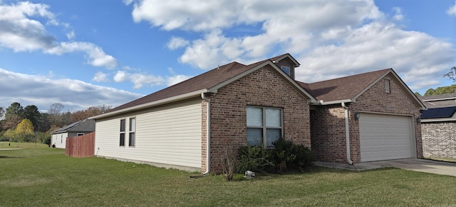 view of side of home featuring a yard and a garage