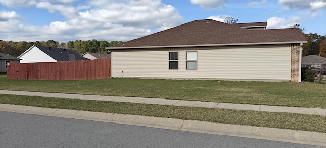 view of side of property with a lawn