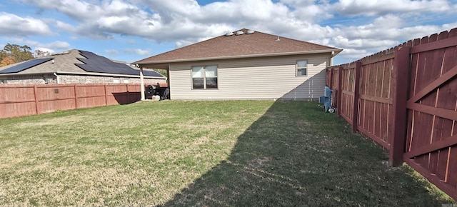 rear view of house featuring a lawn